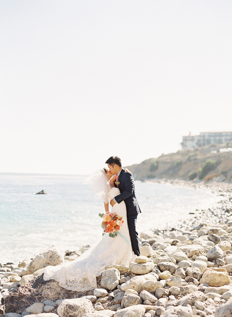 coral beach wedding photo by caroline tran