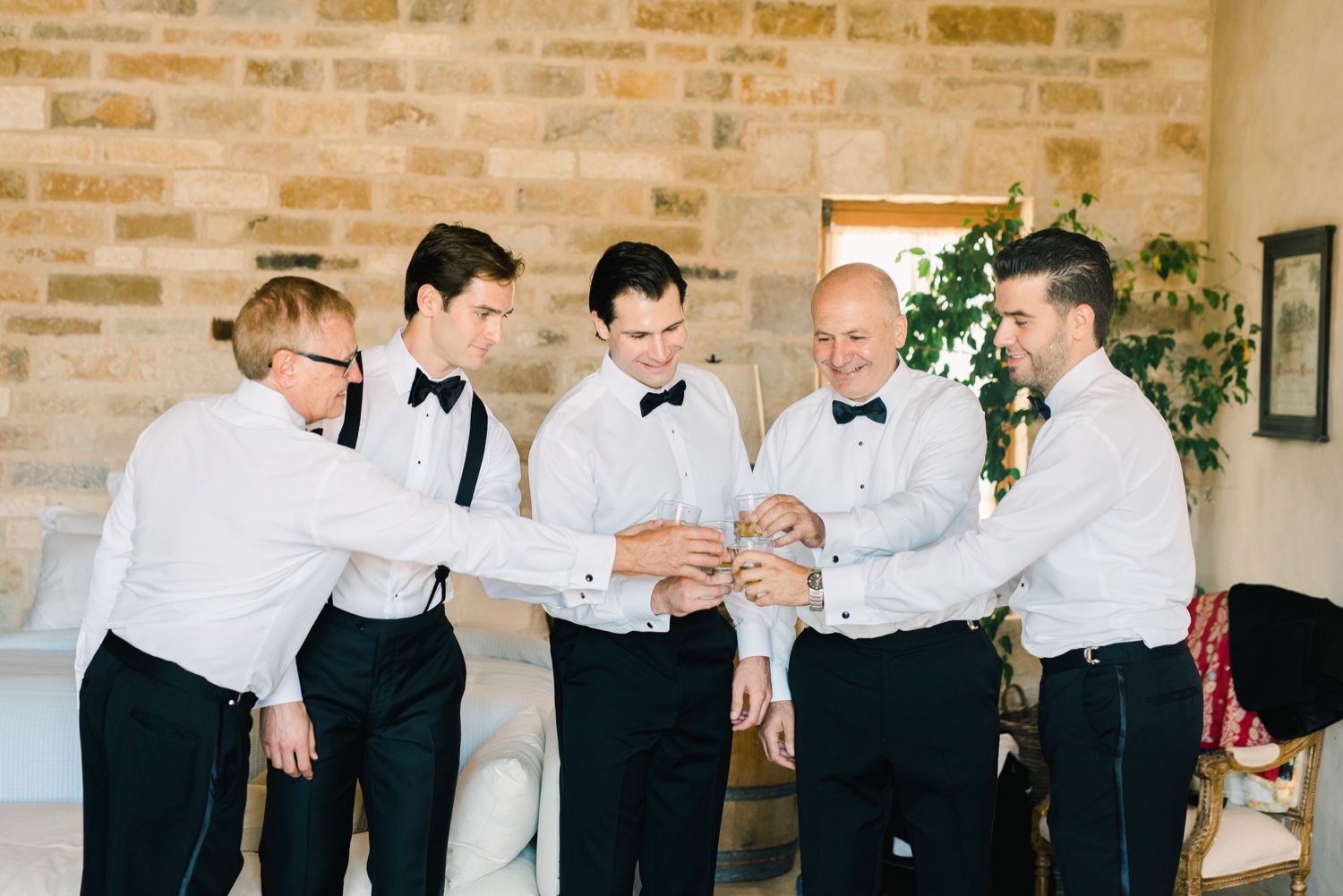 Groomsmen toasting with scotch before ceremony