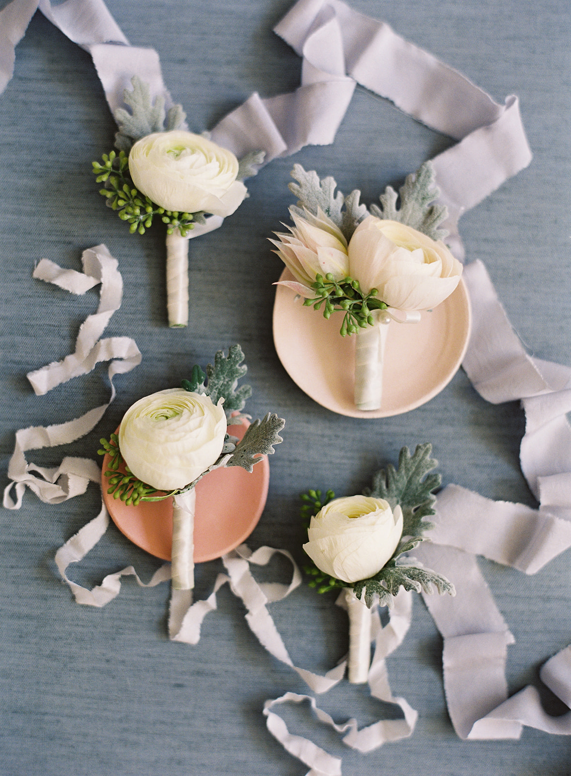 Close up of boutonniers against blue background