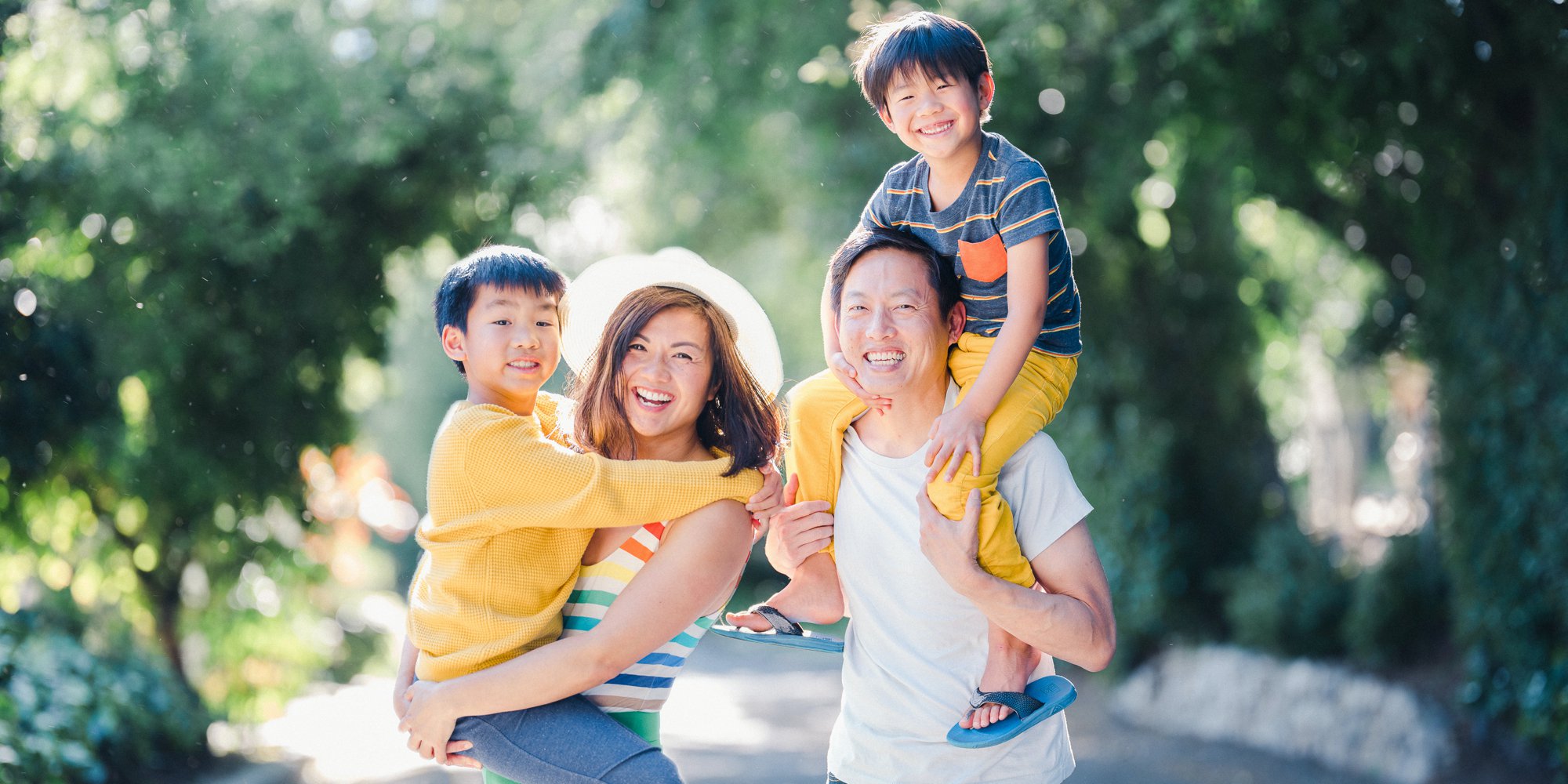 Family of four outside smiling at the camera.