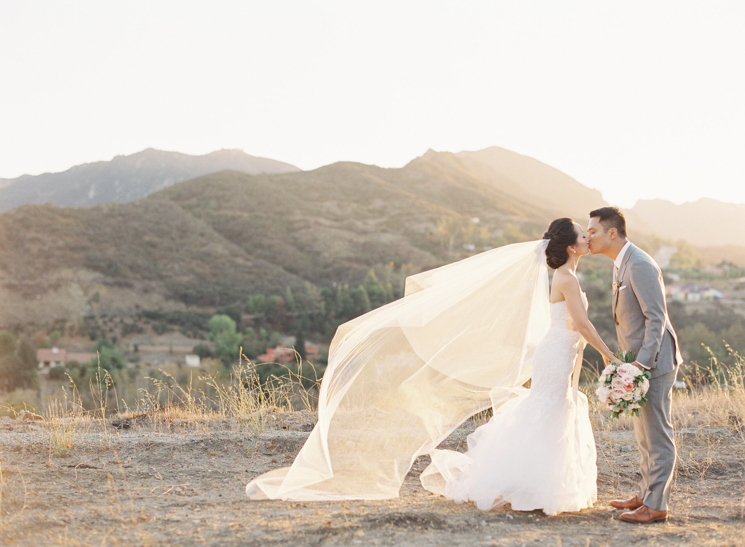 Wedding Couple at Kissing at Sunset on rolling hills at Triunfo Vineyard